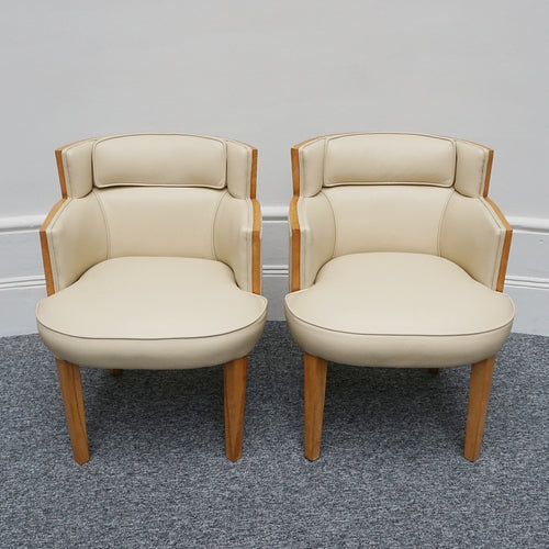 A pair of Art Deco bankers chairs birdseye maple veneered with solid satin birch legs. Upholstered in cream leather and contrasting oatmeal faux suede.