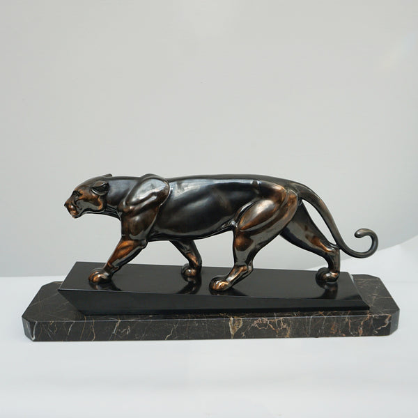 An Art Deco spelter sculpture of a stalking panther by Irénée Rochard. Set over a marble base. 