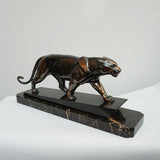 An Art Deco spelter sculpture of a stalking panther by Irénée Rochard. Set over a marble base. 
