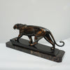 An Art Deco spelter sculpture of a stalking panther by Irénée Rochard. Set over a marble base. 