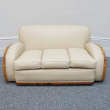 An Art Deco three piece tank Sofa by Heals of london. Made of Burr and solid walnut banding with reeded lower section, Upholstered in cream leather and contrasting faux suede