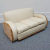 An Art Deco three piece tank Sofa by Heals of london. Made of Burr and solid walnut banding with reeded lower section, Upholstered in cream leather and contrasting faux suede