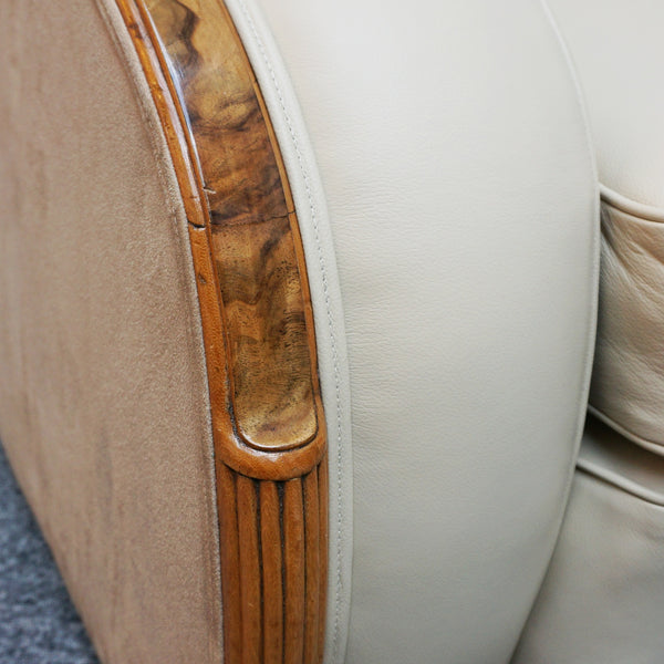 An Art Deco tank chairs by Heals of london. Made of Burr and solid walnut banding with reeded lower section, Upholstered in cream leather and contrasting faux suede