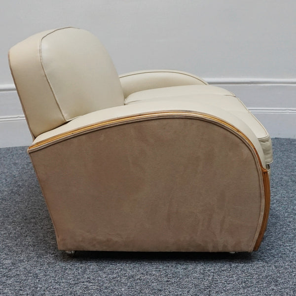 An Art Deco tank chairs by Heals of london. Made of Burr and solid walnut banding with reeded lower section, Upholstered in cream leather and contrasting faux suede