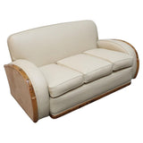 An Art Deco three piece tank Sofa by Heals of london. Made of Burr and solid walnut banding with reeded lower section, Upholstered in cream leather and contrasting faux suede