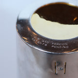 An Art Deco, silver plated and gilt recipe cocktail shaker. Integral strainer. Outer  sliver plated cover revealing brass underlayer with ingredients for various cocktails. Stamped 'Napier' to underside at Jeroen Markies.
