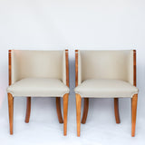 A pair of Art Deco tub chairs. Veneered walnut wrap frame. Solid satin birch legs. Upholstered in cream leather at Jeroen Markies.