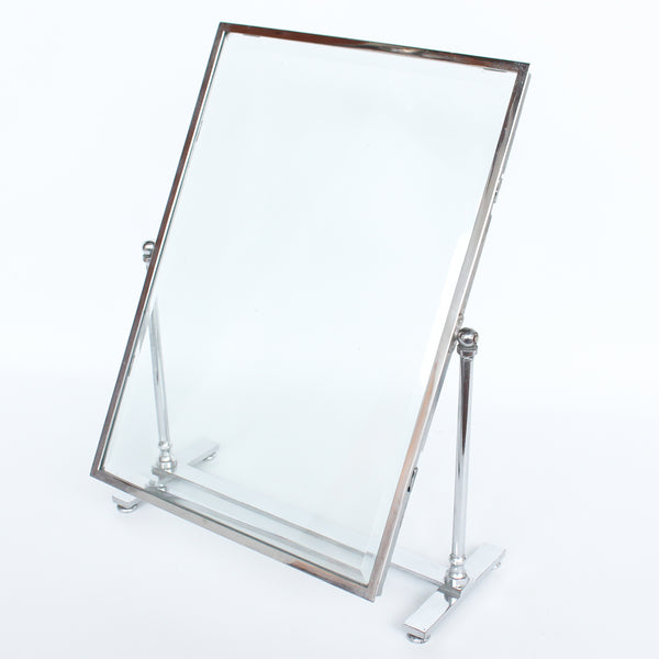 An Art Deco photo frame, on a chrome base, beveled glass liners at Jeroen Markies.