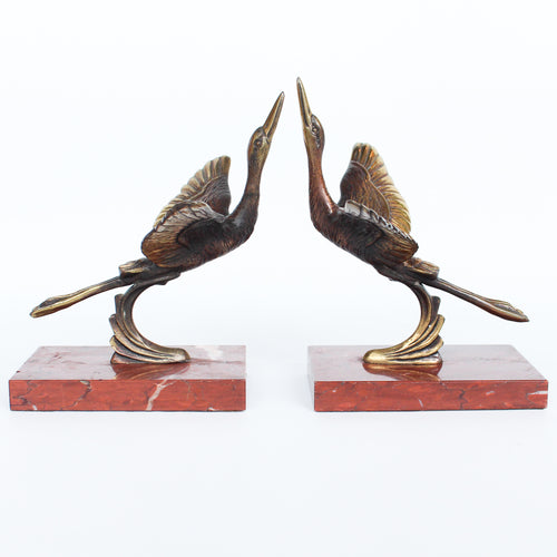 A pair of Art Deco, bronze bookends in the form of two marabou storks. Set over marble plinths. 