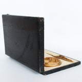A gilt bronze and onyx in a bird motif, including letter opener and inkwell tray. In fitted presentation case. All signed, 