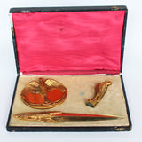 A gilt bronze and onyx in a bird motif, including letter opener and inkwell tray. In fitted presentation case. All signed, 