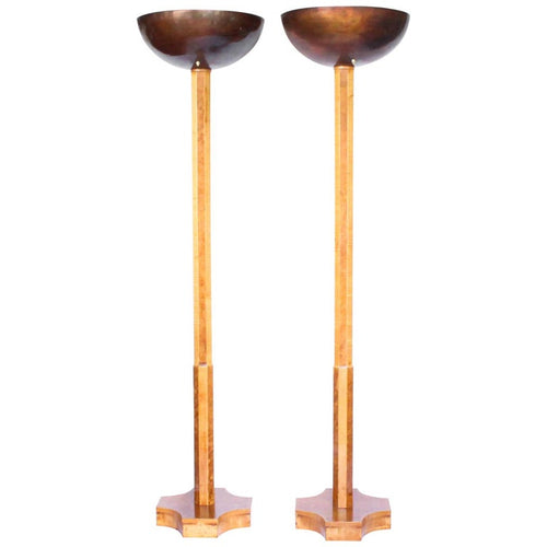 A pair of Art Deco uplighter floor lamps by Harry & Lou Epstein. Made of walnut and satin wood with domed copper shades.