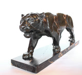 An Art Deco, patinated bronze study of a prowling tiger, set over an integral marble base. Signed to marble at Jeroen Markies