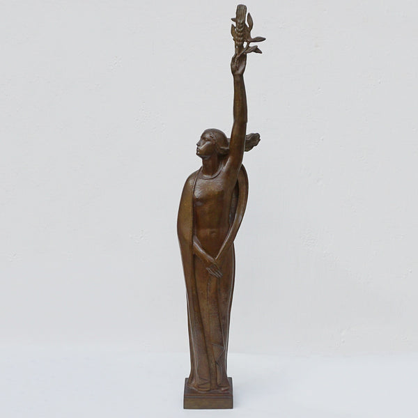 An Art Deco bronze sculpture of Ceres the Roman goddess of agriculture, fertility and motherly relationshios, holding alot a strand of wheat, bear breasted with a shawl around her and her hair flowing in the wind by André Bizette-Lindet 