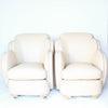 A pair of Art Deco, cloud back armchairs, re-leathered in cream leather at Jeroen Markies.