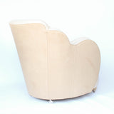 A pair of Art Deco, cloud back armchairs, re-leathered in cream leather at Jeroen Markies.
