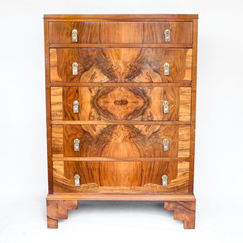 Art Deco walnut chest of drawers. Original gilt bronze handles. Mahogany lined drawers. Stepped bracket feet at Jeroen Markies.