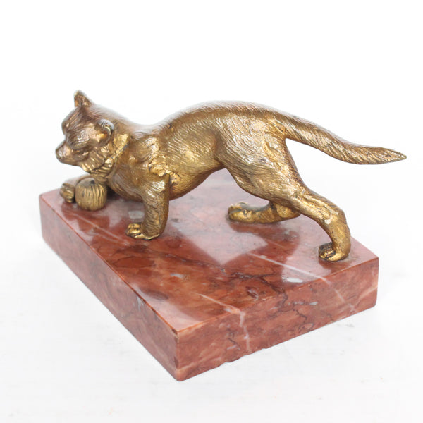 An Art Deco, gilt bronze sculpture of a cat playing with a ball of yarn. Set over a marble plinth and signed Richard to marble at Jeroen Markies