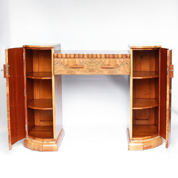 An Art Deco console sideboard by Hille. Burr walnut veneer throughout. Scallop-edged detail to front with integral drawer. Shelved cabinets to either side.