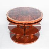 Art Deco, figured walnut veneer nest of tables. A shaped table with cross-footed base and four integral side tables. Burr and straight grain walnut throughout with birdseye maple border.