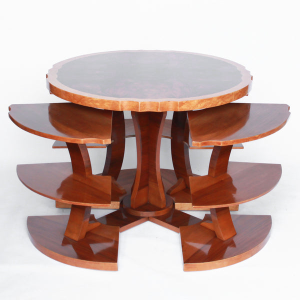 Art Deco, figured walnut veneer nest of tables. A shaped table with cross-footed base and four integral side tables. Burr and straight grain walnut throughout with birdseye maple border.