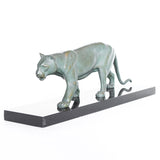 An Art Deco, patinated bronze study of a prowling lioness, mounted on a black marble base. Signed 'M. Leduc' at Jeroen Markies.