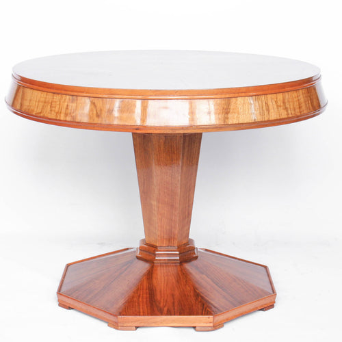Round centre table in veneered walnut with octagonal base and central column. Table top veneered in quartered figured walnut with solid walnut edging at Jeroen Markies