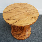 An Art Deco style centre table with a curved central column with hidden shelf to either side set over a circular base made from burr walnut veneer