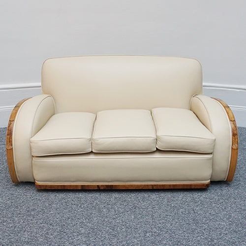 An Art Deco three piece tank suite by Heals of london. Made of Burr and solid walnut banding with reeded lower section, Upholstered in cream leather and contrasting faux suede