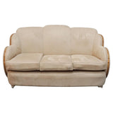 An Art Deco cloud back sofa by Harry & Lou Epstein with figured walnut banding to the arms and upholstered in cream faux suede