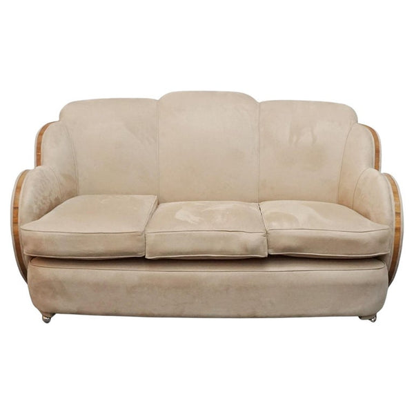 An Art Deco cloud back sofa by Harry & Lou Epstein with figured walnut banding to the arms and upholstered in cream faux suede