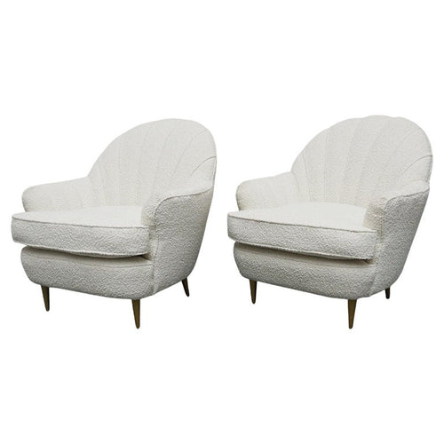 A pair of Mid Century lounge chairs upholstered in white Bouclé with metal and brass capped feet. Designed by Gigi Raddice for Minotti. 